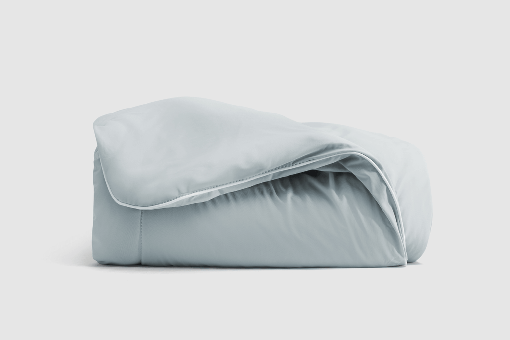 Coop Sleep Goods CoolSpa cooling blanket in blue-grey showing breathable nylon weave